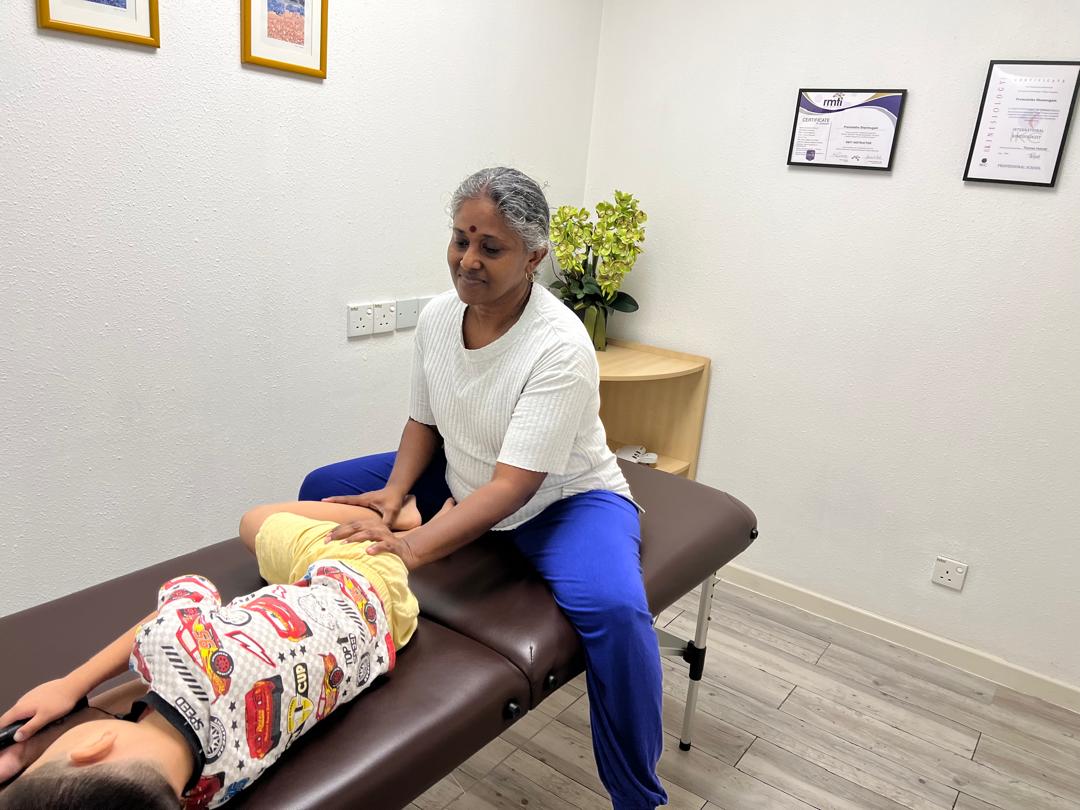 Premalatha performing a gentle Emmett Technique muscle release