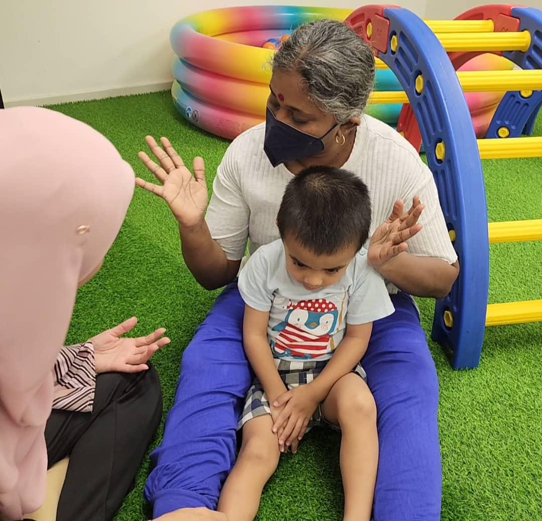 Premalatha volunteering with a young child with special needs at MHHO